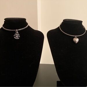Two silver tone bracelets with charms. Angel and heart.